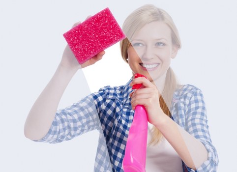 Professional cleaner inspecting carpet condition before treatment